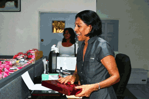 First Lady Deolatchmee Ramotar completes wrapping a Christmas present she selected for a less fortunate child alt
