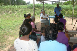 Minister Norman Whittaker speaking to residents in Cabrora, Region 1 alt