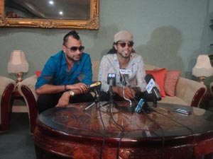Ravi B of Karma Band and Kes of Kes and the Band address the media at the CJIA yesterday