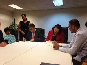 Guyana’s Minister of Foreign Affairs Carolyn Rodrigues-Birkett and Venezuelan Foreign Minister Elias Jaua Milano, signing the joint statement yesterday in the presence of members of their respective delegations, following their meeting in Port of Spain, Trinidad and Tobago.