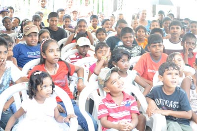 Children entertained by a performer at the Christmas Party