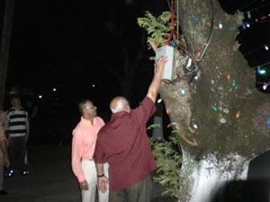 President Ramotar flicks the switch to illuminate the trees for the first time in the National Park