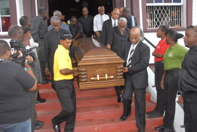 The casket bearing the remains of Terrence Ormonde Holder, being taken out of the St. Andrew’s Kirk following the service. Among the pallbearers is West Indies superstar batsman, Shivnarine Chanderpaul