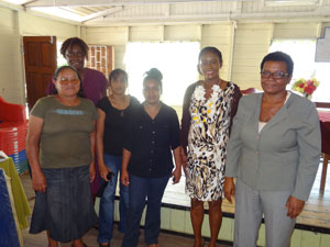 Minister Webster with Chairperson of the Group Ms. Gwendoline DeJesus; Headmistress of the Long Creek Primary, Ms. Alcey Welch, and other school staff and residents following the presentation