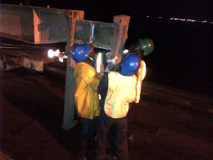 Workers putting on the connecting posts on the new transom which replaced the damaged one