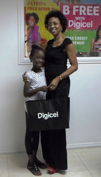 Terriann Wright in embrace with Digicel Guyana Head of Marketing, Jacqueline James on Monday.