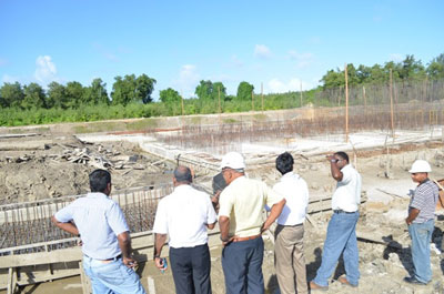Minister of Agriculture Dr. Leslie Ramsammy and Chief Executive Officer, National Drainage and Irrigation Authority, Lionel Wordsworth, in discussion with the contractors and engineers at the site of the eight-door, sea-side sluice for the Northern Relief Channel