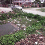 Garbage thrown into irrigation trenches by residents of the village