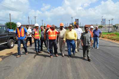 President Donald Ramotar, Minister of Public Works, Robeson Benn and Finance Minister, Dr. Ashni Singh at the Diamond end of the four-lane road, where some level of work has been completed