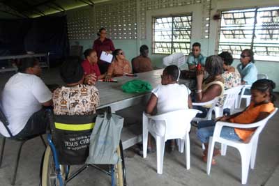 At far left, Tutor Ganesh Singh conducts a class in literacy for students with disability. Standing at left is Administrative Volunteer, Theresa Pemberton