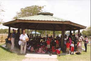 This picture, taken immediately after the presentation ceremony done by the Club’s Community Outreach Chairperson, MsMarva Patterson (left), shows that the facilities are being well utilised for recreational purposes by many other schools and groups