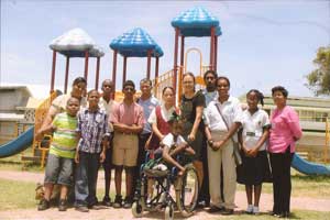 Community Outreach Chairperson Marva Patterson of the Inner Wheel Club of Georgetown poses with Past President Sinikka Henry and representatives of the special schools in front of the centre-piece of the National Park Playground