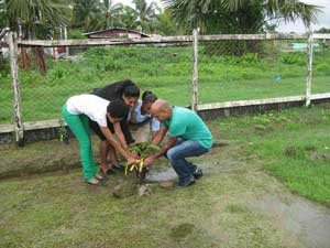 Region 6 Education Officer, Volika Jaikishun, assists members of Berbice Shines and a student in the symbolic tree planting exercise on Thursday last