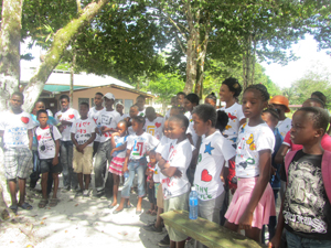 Tiger Bay and Albuoystown children pose with their fabric painted T-shirts which they designed during a session on camp