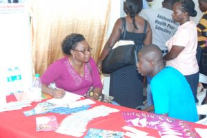 A member of the public interacts with one of the medical practitioners at the fair  