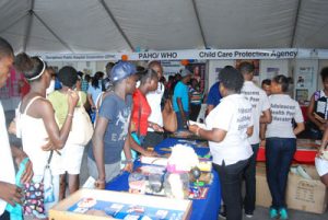 Members of the Youth Friendly Services Organisation interact with attendees  