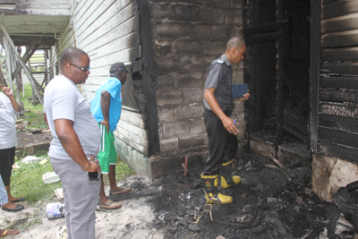 From left, GNNL’s General Manager, Michael Gordon, with a firefighter inspecting some of the damages