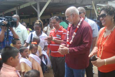 Time for a chat, President Donald Ramotar engages a nursery school student
