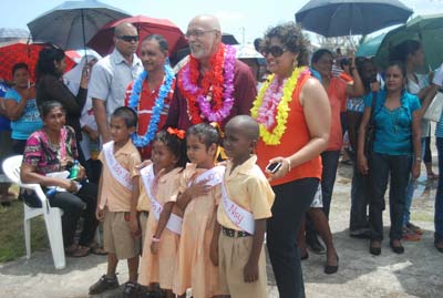 President Donald Ramotar (centre), flanked by Education Minister Priya Manickchand (right), and Regional Chairman Julius Faeber ( left), with students of the Cornelia Ida Nursery School