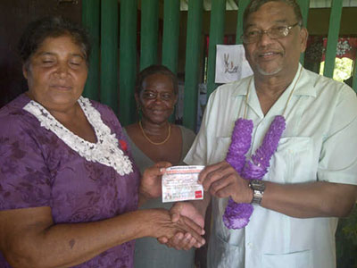 Labour Minister Dr Nanda Gopaul helping in the distribution during his visit to the Essequibo Coast