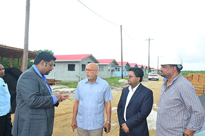 Housing & Water Minister Irfaan Ali explains the progress of the housing projects to President Donald Ramotar and Finance Minister Dr Ashni Singh; looking on is Mr. Motielall (a Contractor)