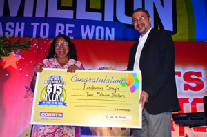 Latchmini Singh receiving her symbolic $2M cheque from Courts Guyana Managing Director, Mr Clyde de Haas (Photos by Adrian Narine)