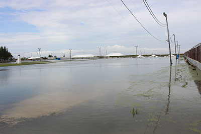 A wide shot of a flooded Camp Ayanganna ground.