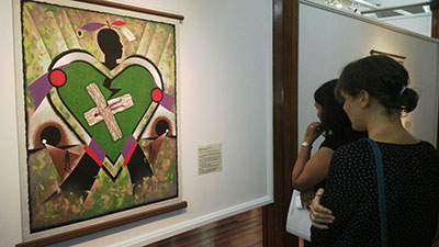 Guests observing a painting in ‘Dialogue With Wilson Harris’.