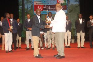 An outstanding performer among the group of Gold awardees being presented with his trophy from Prime Minister, Mr Samuel Hinds 