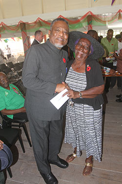Prime Minister Hinds poses with Ms. Norma Scott, who at age 82 is the oldest female ex-soldier alive. Enlisted in the first batch, her regulation number was Pte. 3181