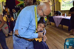 This little lass from Kaikan, gets a presidential hug