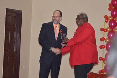 Chairman of the Guyana Manufacturing and Services Association, Clinton Williams receives the Lifetime Award for long and dedicated service to the Public and Private Sectors from CARICOM Secretary General, Irwin LaRocque