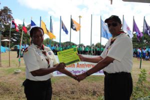 The late Ms. Marcia Jennifer Dey receiving, in 2013, an award for exemplary service to SAG from  Chief Scout Ramsay Ali 