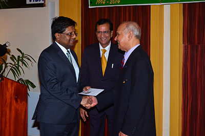 Finance Minister, Dr. Ashni Singh (left) being presented with a Demerara Bank Visa Credit Card by Company Chairman, Dr. Yesu Persaud. Looking on at centre is Demerara Bank CEO, Mr Pravinchandra Dave