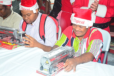 PRRC inmates playing with their new toys, compliments of Digicel Guyana, during a Christmas party held yesterday.