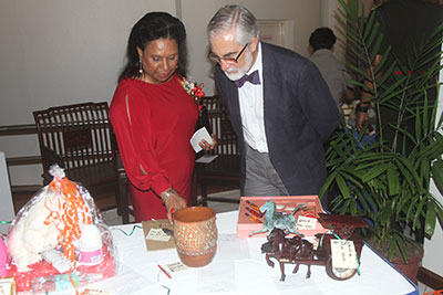 Mrs. Yvonne Hinds with Mexican Ambassador to Guyana, Francisco Olguin looking at the items on auction