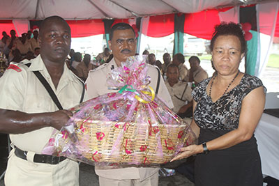 Assistant Commissioner, Mr David Ramnarine donates a hamper to the mother of a fallen police officer