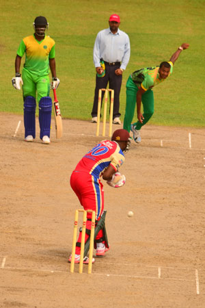 Well played Barney! Umpire Zaheer Mohammed and non-striker Raymon Reifer look on quizzically as Guyana Jaguars skipper Christopher Barnwell gets ready to play this delivery from fast bowler Paul Wintz, during his team’s innings yesterday. (Photo by Adrian Narine)