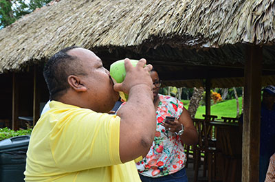 Acting Deputy Minister of Agriculture, Djoemadie Kasanmoesdiran, enjoying a refreshing drink of Guyanese coconut water