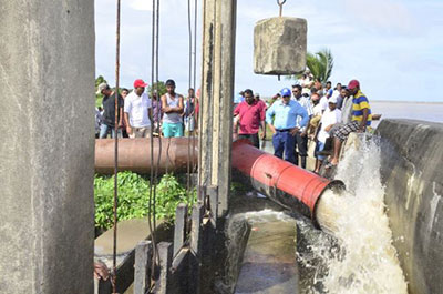President Donald Ramotar with officials and residents at an Outfall on the Essequibo