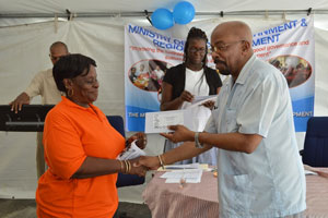A typist-clerk receives her token of appreciation from Minister of Local Government, Mr Norman Whittaker