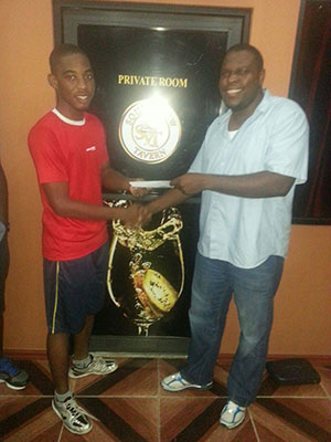 Inaugural champion Shemar Britton (L) receives his reward from SVT proprietor Dillon Griffith.