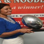 Beharry’s Marketing Director Anjuli Beharry-Strand poses with the 2014 NACRA 7s Championship Trophy