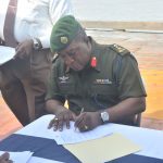 Chief of Staff, Brigadier Mark Phillips signs the MOU 