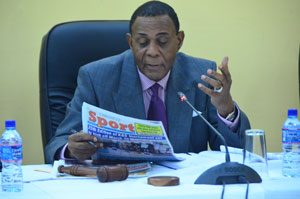 COI Chairman Sir Richard Cheltenham catching up with the front page of the Guyana Chronicle ahead of yesterday’s hearings  