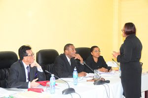 COI Counsel Latchmie Rahmat (standing) engages the Commissioners during yesterday’s hearing