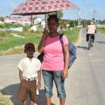  Best Village resident, Tina, and her son, standing on this stretch of road that gets lonely and eerily dark and dangerous in the nights due to a lack of street lights. 