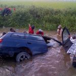 The car in which the seven were travelling when they met their demise, even as their bodies can be seen lying on a dam nearby