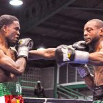 Guyana’s Clive Atwell (left) connects to Jamaican Mullings’ jaw with a long range left hook (Photo by Delano Williams).