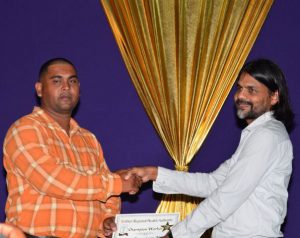 A proud sponsor of the event, Yog Mahdeo handing over the Champion Worker award to driver/mechanic Perry Phillips